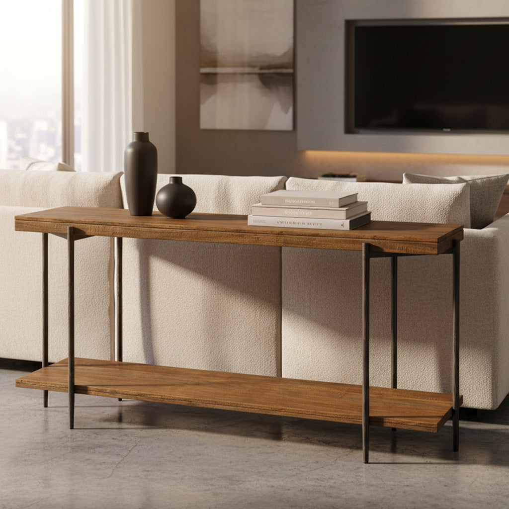 Solid mango wood sofa table with forged iron base, lower shelf, decorative vases, and stacked books in living room