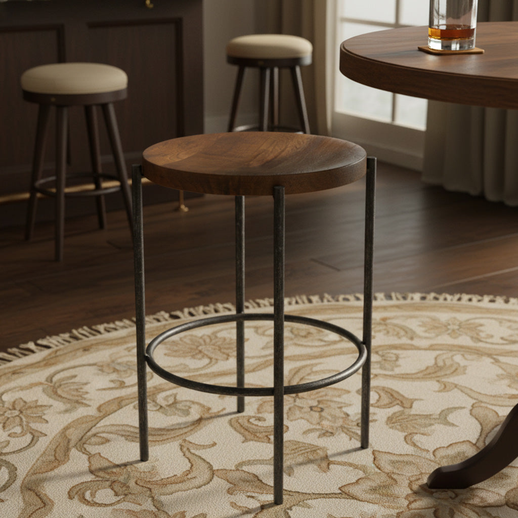 Brown wooden Bedford Park counter stool with metal legs on patterned rug near round wood table and stools