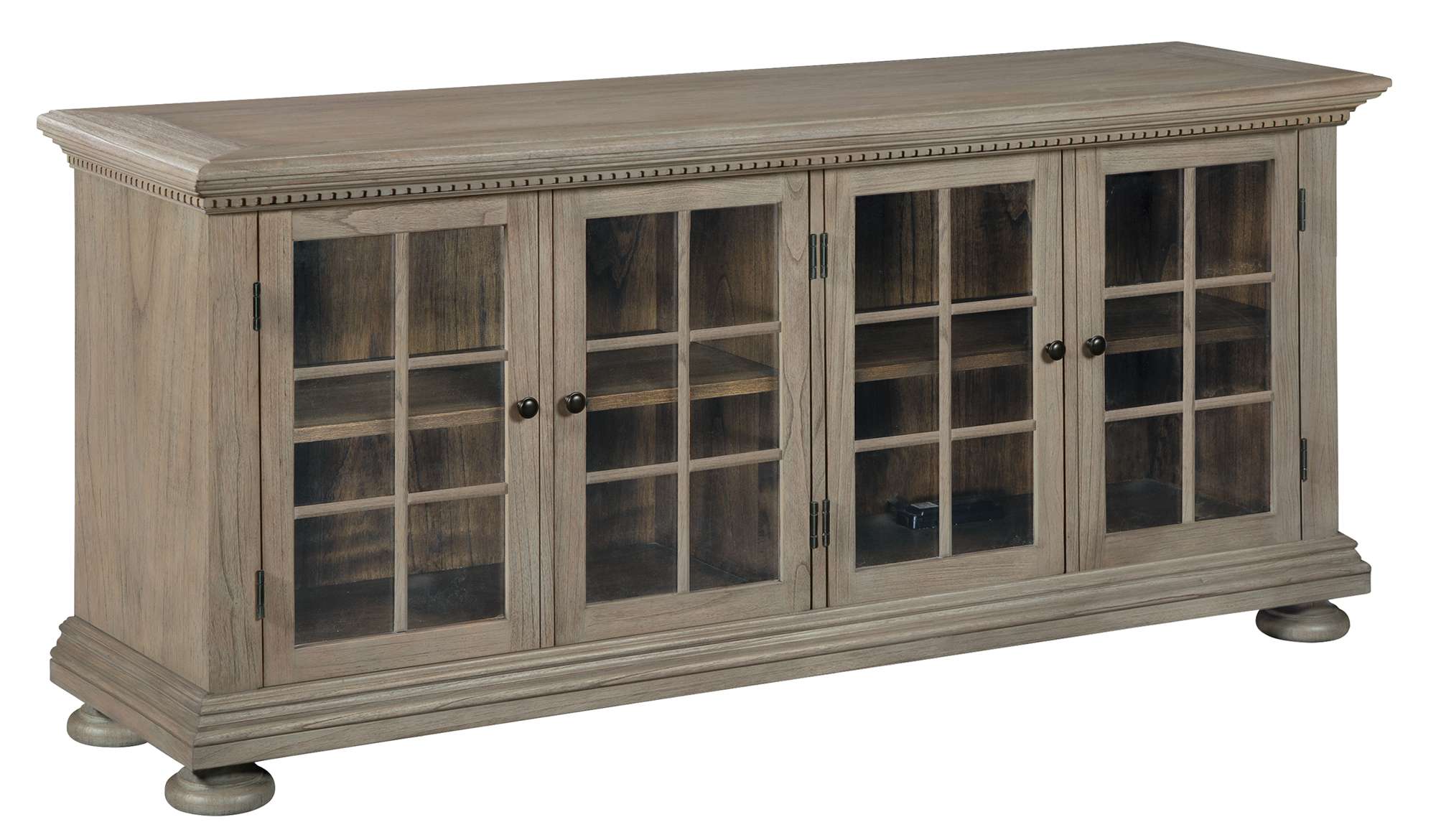 Rustic mindi wood entertainment console with four glass doors, decorative mullions, adjustable shelves, and antique brass hardware