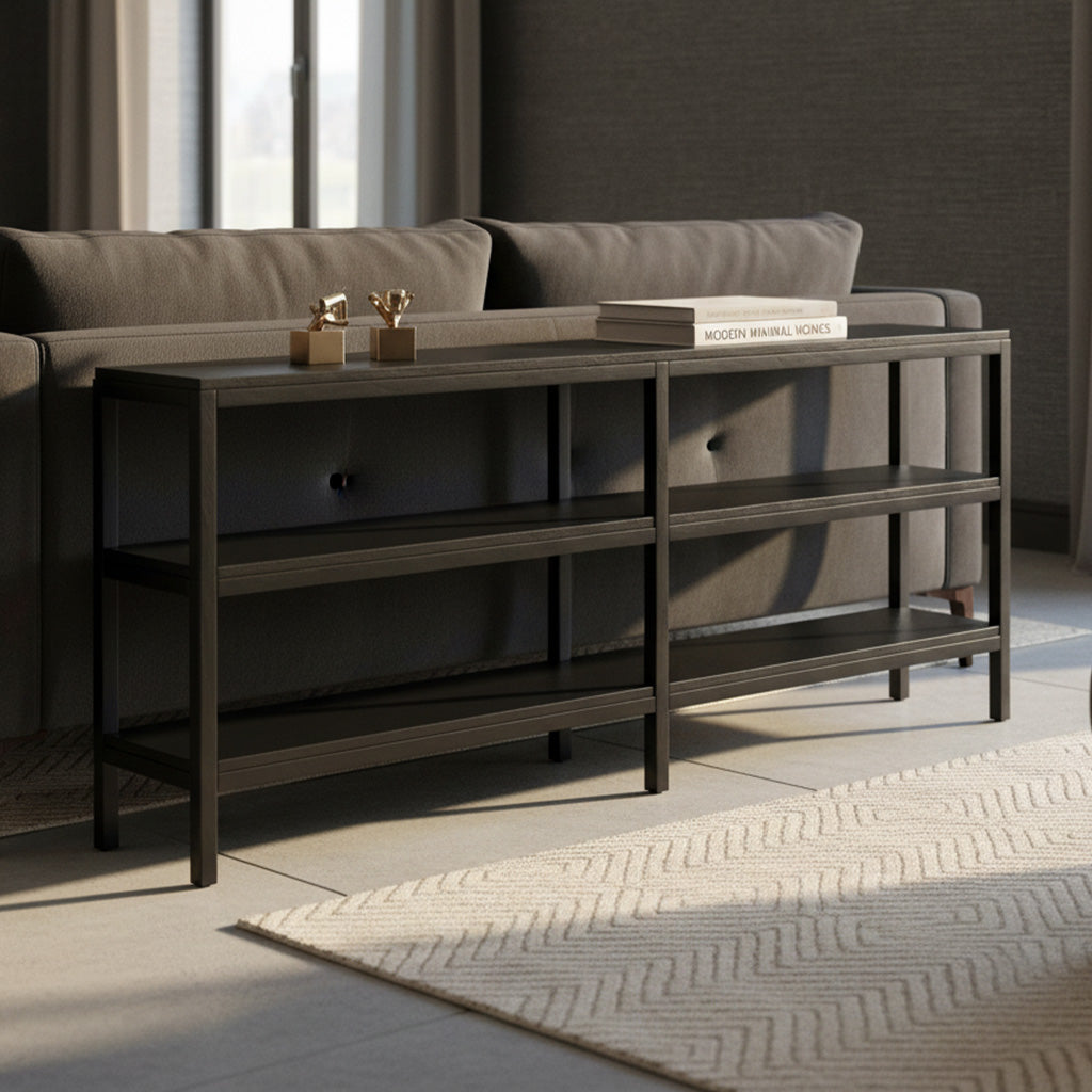 Dark wood sofa table with three open fixed shelves positioned behind gray tufted sofa in bright living room