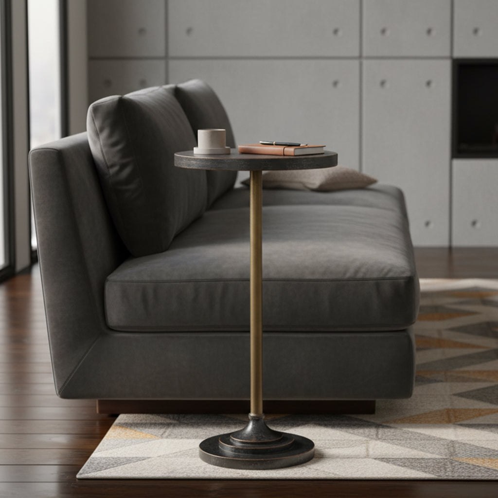 Slim Hekman End Table with round black Louie Phillippe finish top, brass pedestal base, and compact versatile design next to gray sofa