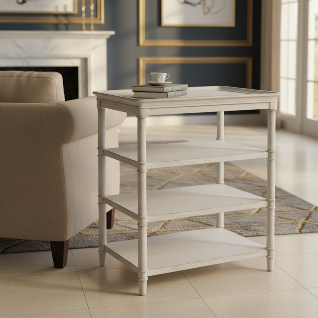 Three-shelf end table with aged white finish, turned leg posts, and classic design in elegant living room setting