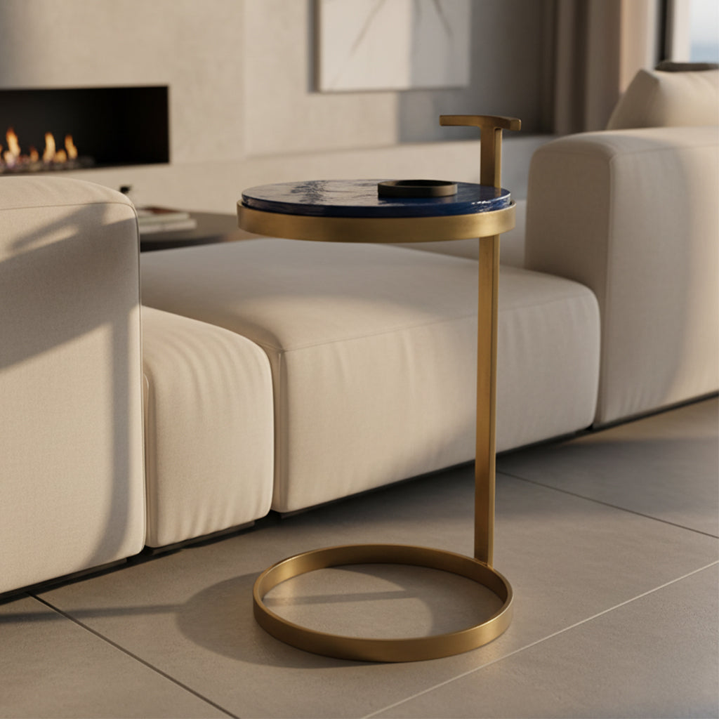 Round brass end table with blue hand-poured glass top insert and minimalist C-shaped frame design