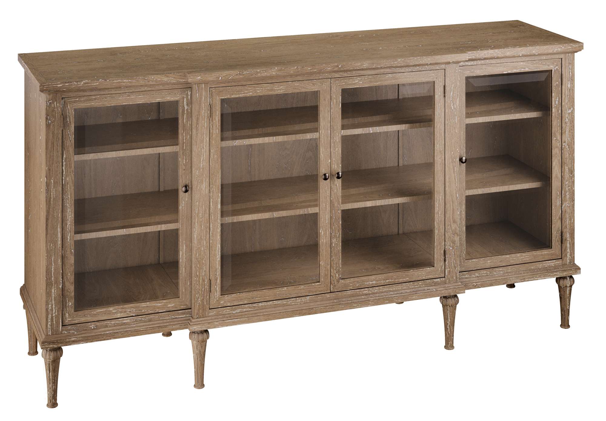 Chateaux Entertainment Console with four glass-paneled doors, open shelving, and carved wooden legs in weathered finish