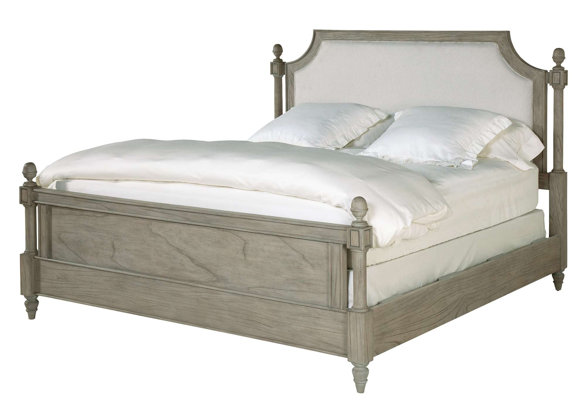 Wellington Estates queen bed with mindi veneers and solids, upholstered headboard panel, round posts, decorative medallions, and turned finials