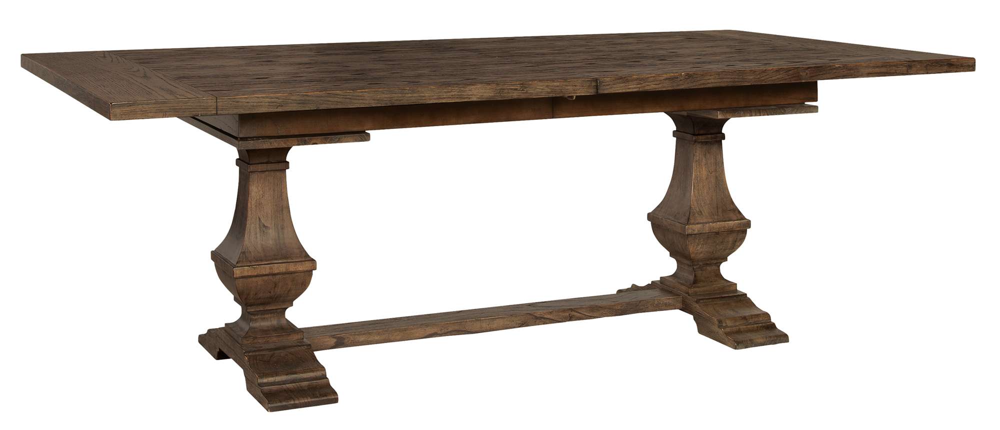 Wexford dining table with 1-1/2" oak veneer top, carved bulbous mindi wood pedestals, and trestle base finish