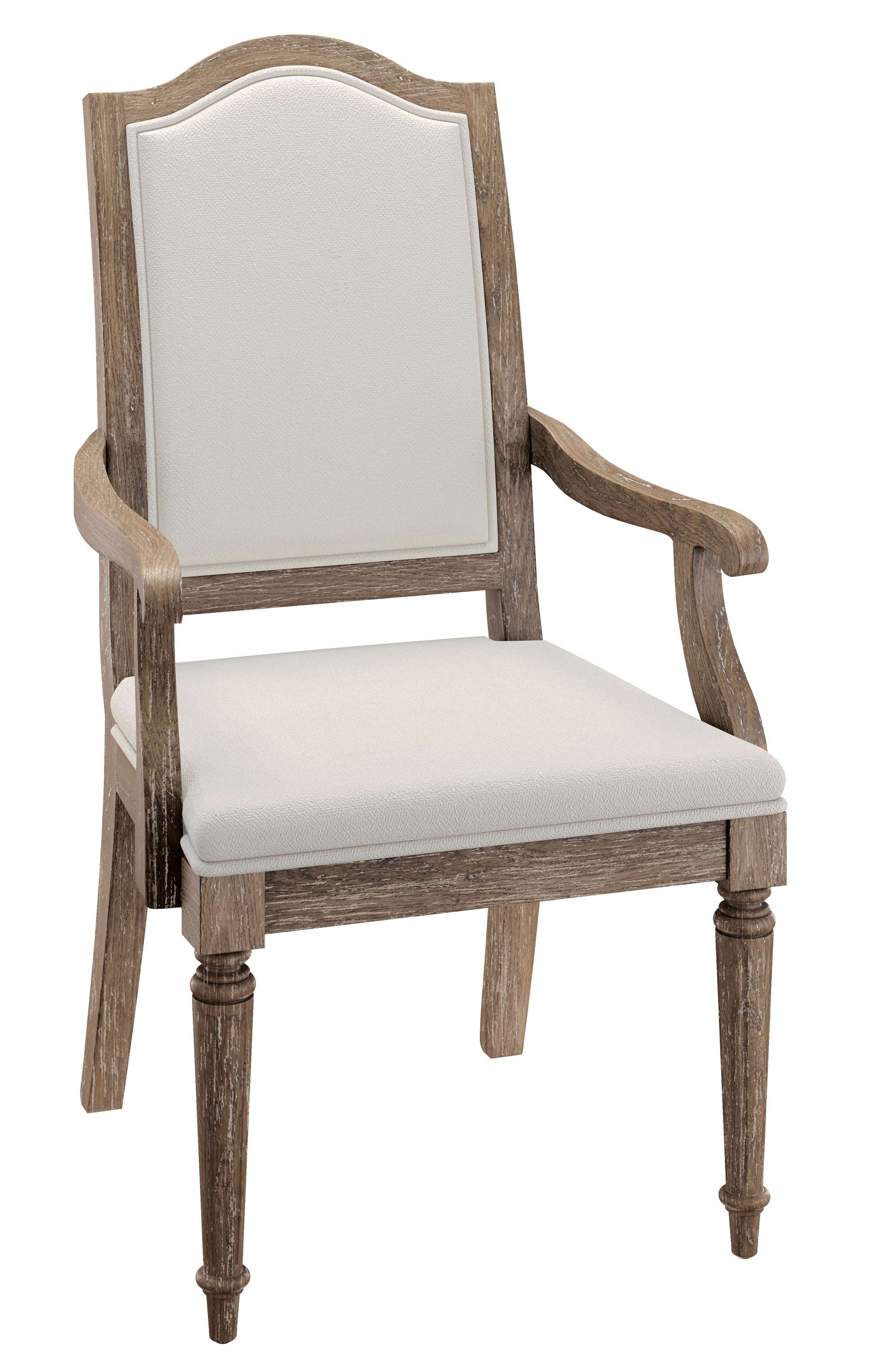 Upholstered arm chair with carved wood arms, tone-on-tone fabric, and weathered wood frame in classic design