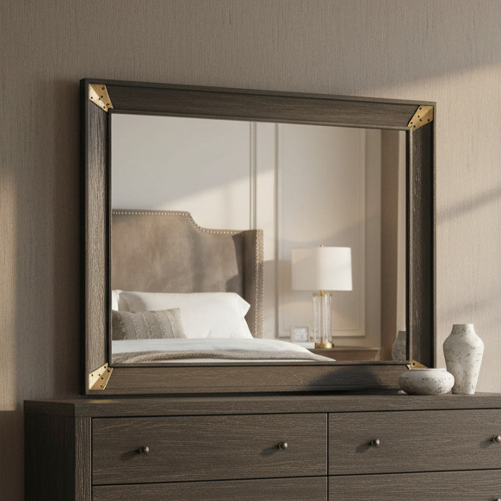 Square oak-framed mirror with beveled glass and decorative brass corner brackets on dark wood dresser surface