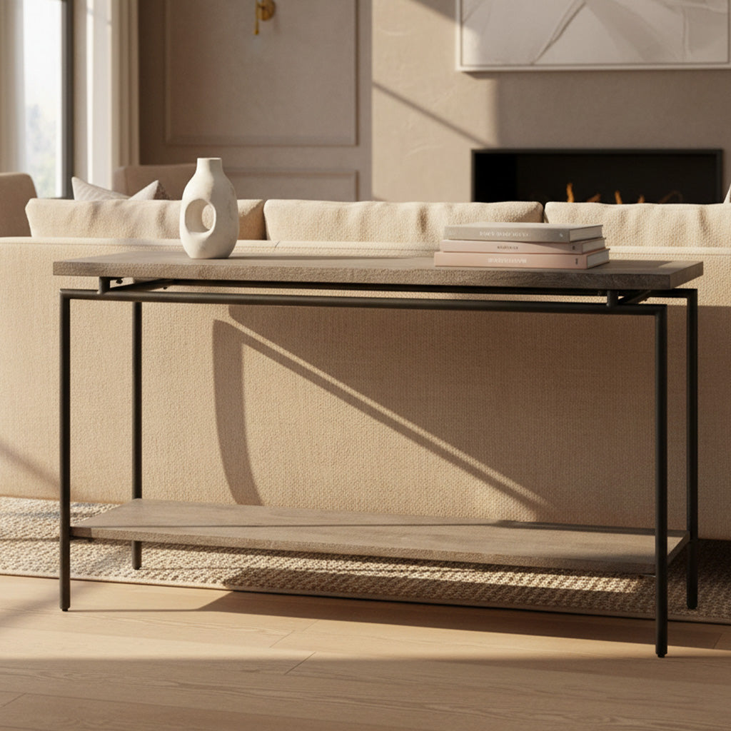 Sofa table with solid mango wood slab top and shelf supported by slim round black iron legs in modern living room