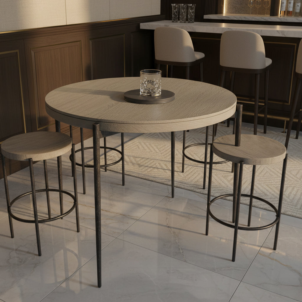 Round gray pub table with three matching stools featuring black metal legs in modern home bar setting