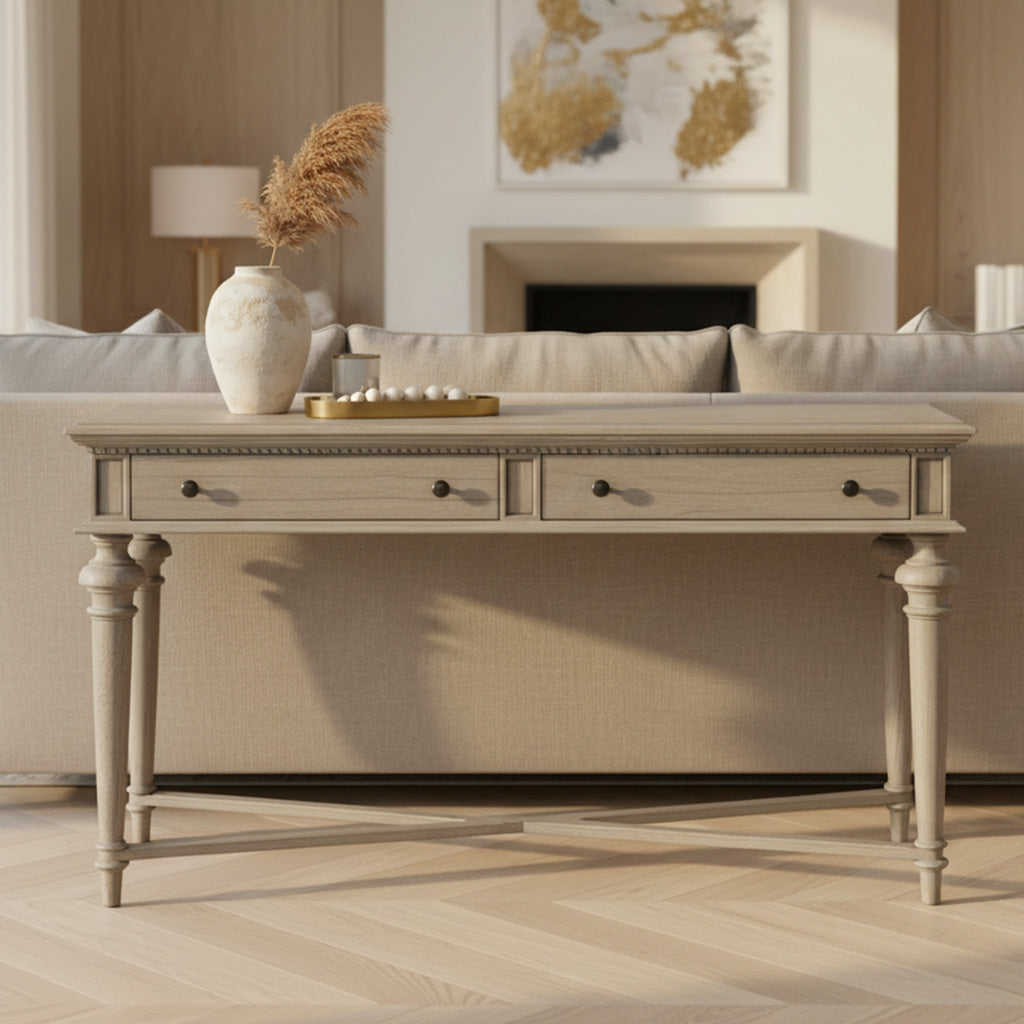 Wellington Estates sofa table in driftwood finish with tapered turned legs, two drawers, brass hardware, and dentil molding