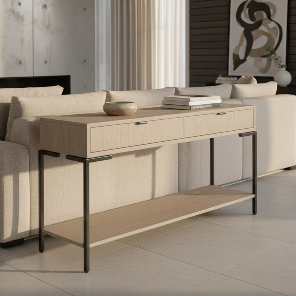 Light wood Scottsdale sofa table with two drawers, metal legs in aged iron finish, decorative items, and beige sofa background