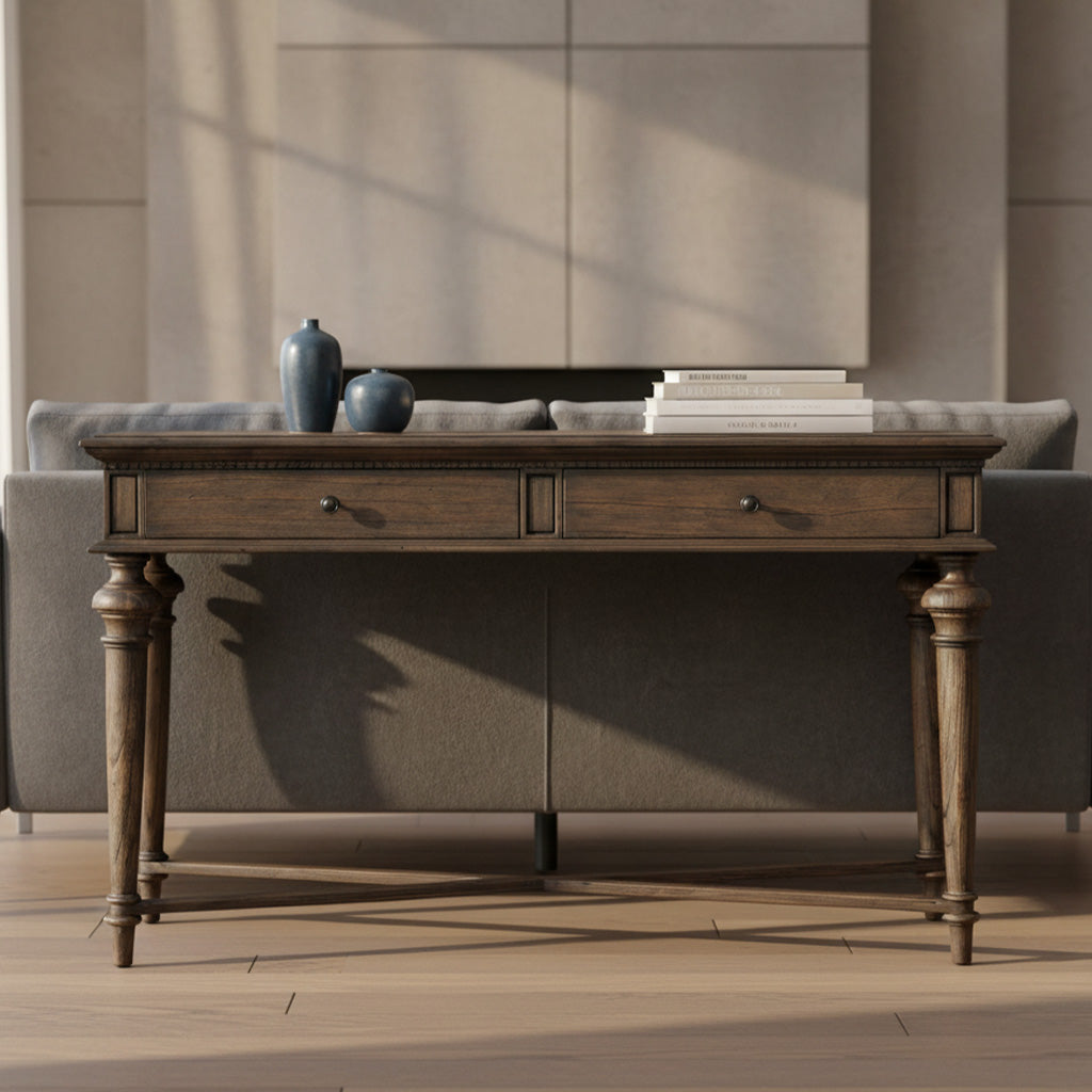 Dark wood Wellington Estates sofa table with two drawers, turned legs, dentil molding, and rustic brass hardware in living room