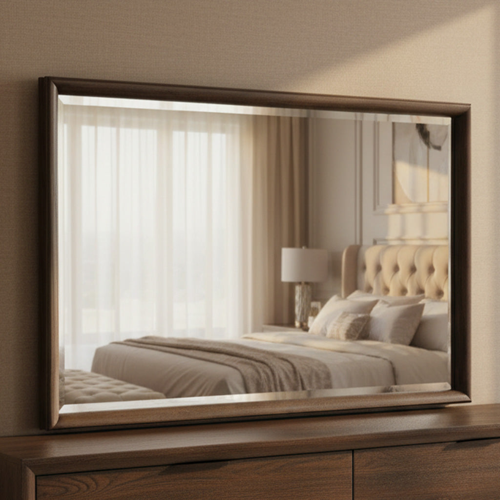 Rectangular wall mirror with beveled glass and deep 2.5-inch carved Linwood finish frame above dark wood dresser