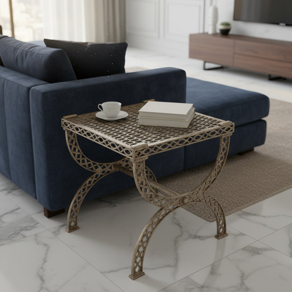 Square cast aluminum end table with open lattice design and curved legs in living room setting