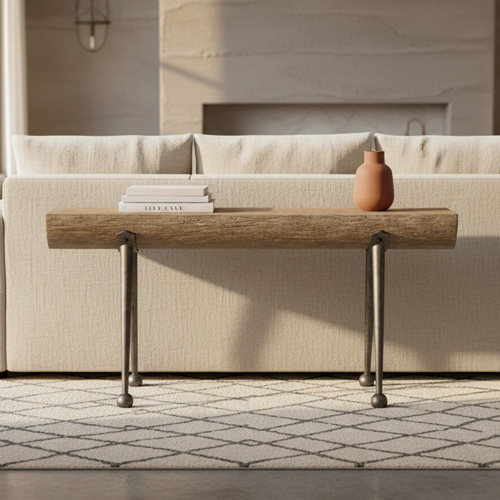 Rectangular sofa table with rustic wood top and black iron tinker toy legs against beige sofa on patterned rug
