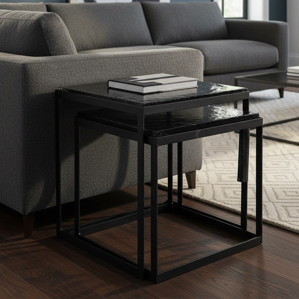 Set of two nesting tables with black hammered iron frames and rectangular glass tops in modern living room setting
