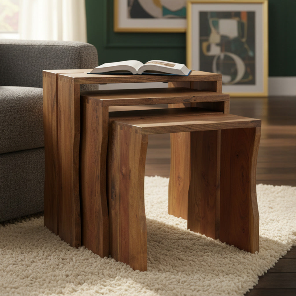 Set of three solid Acacia nesting tables with natural wood finish and exposed dovetail joinery on a cream rug