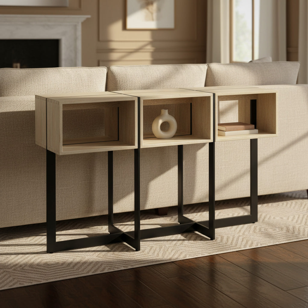 Geometric mango wood sofa table with open storage, black metal legs, and translucent rustic white finish behind beige sofa