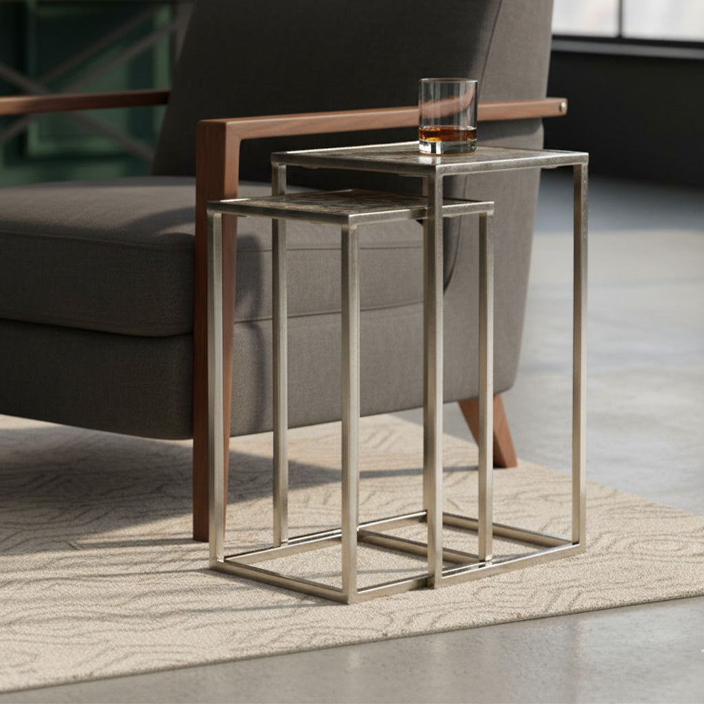 Set of two nesting tables with rectangular sleek metal bases and matching metal tops in modern design