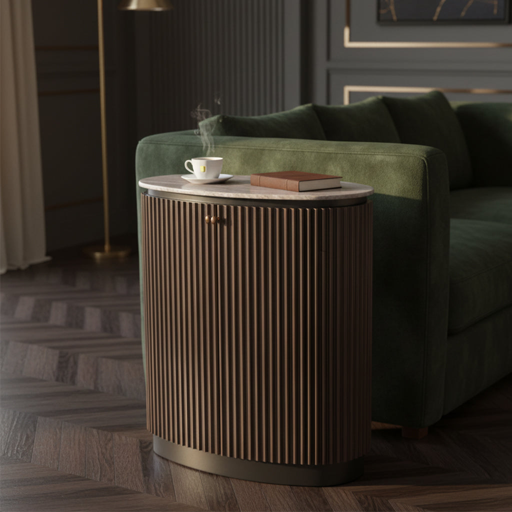 Two door cabinet with vertical slatted wood design, rounded edges, brass handles, and marble top next to green sofa