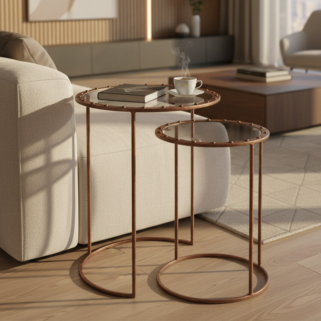 Nesting tables with glass tops, copper-plated iron frames with rivets, large and small round tables in living room setting